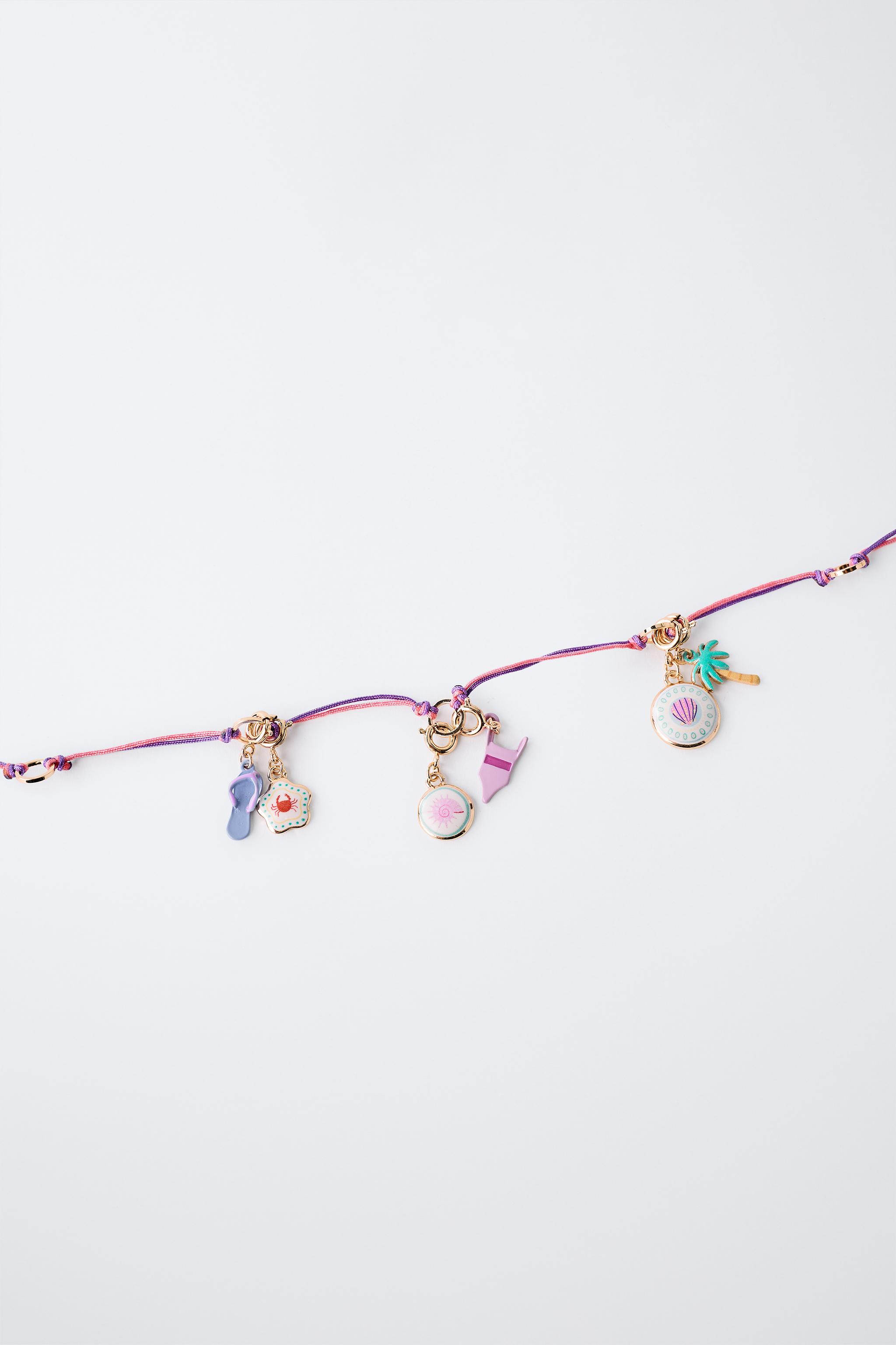 INTERCHANGEABLE MULTI-CHARM NECKLACE
